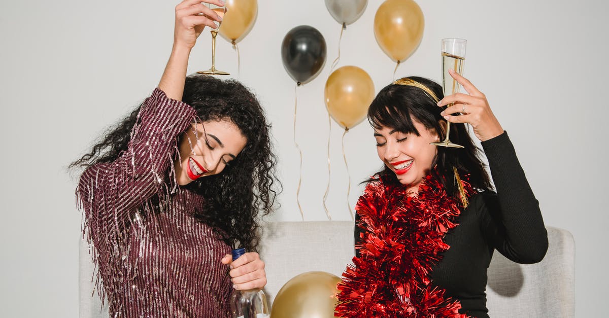 How do I make my friend Notable? - Cheerful friends with glasses of tasty champagne smiling and congratulating each other among balloons