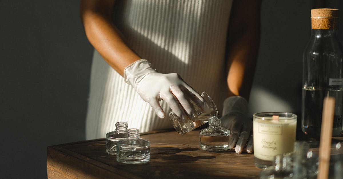 How do I make this command in Minecraft? - Unrecognizable crop African American female pouring essential oil in glass bottle while making liquid incense at table