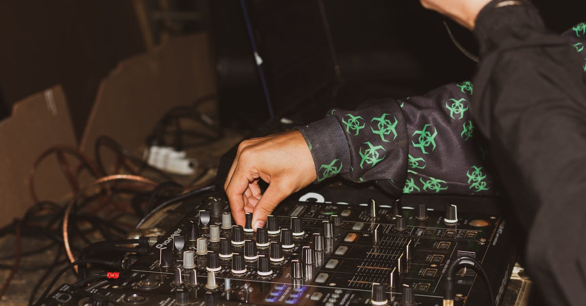 How do I manage leveling up my party? - Crop DJ managing music on music console in studio