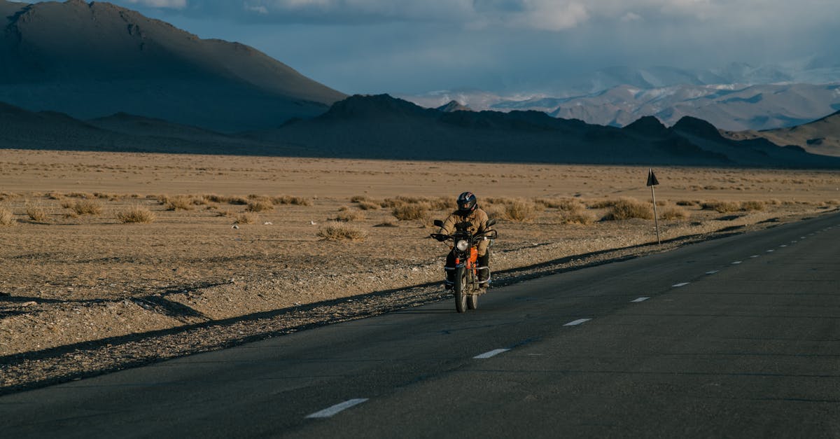 How do I move a rock? - Unrecognizable biker riding motorcycle in countryside