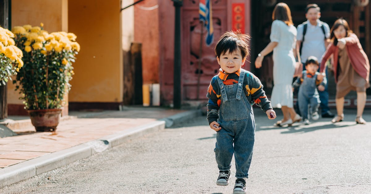 How do I move my family to Windhelm? [duplicate] - Happy ethnic toddler running away from parents during walk in park