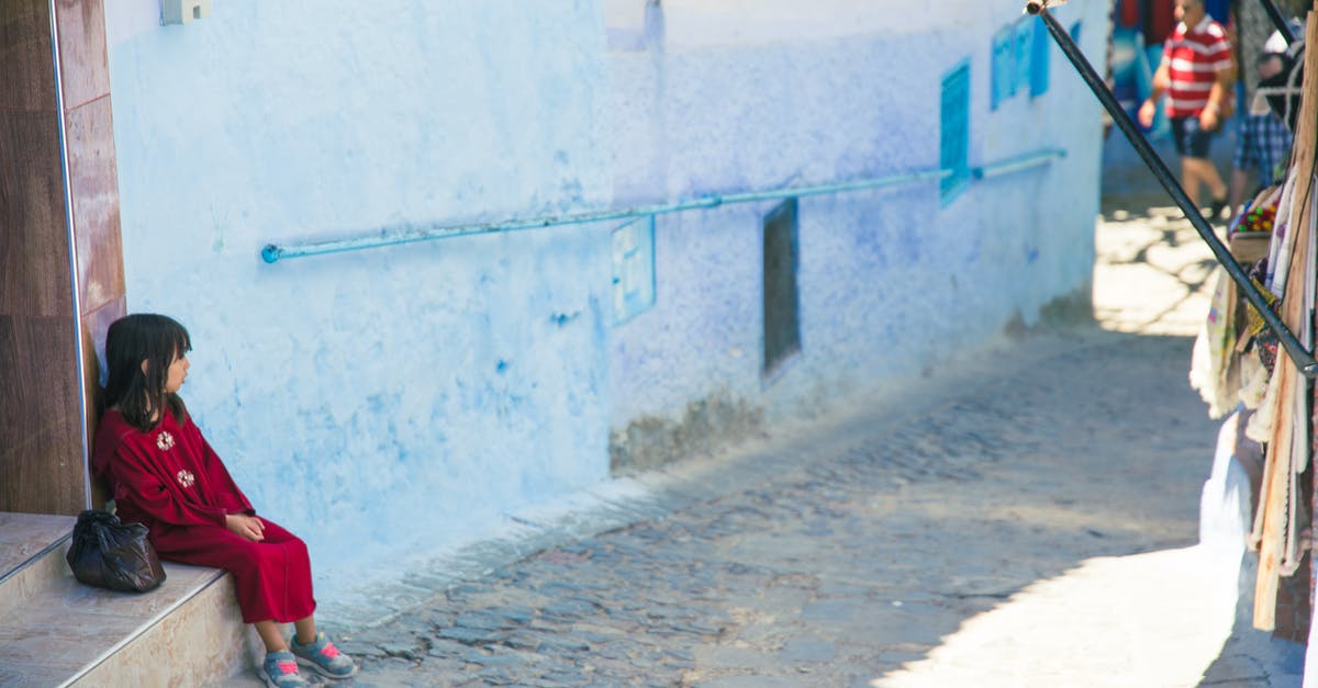 How do I purchase a game on Origin? - Girl sitting on street stairs in indigenous outdoor market