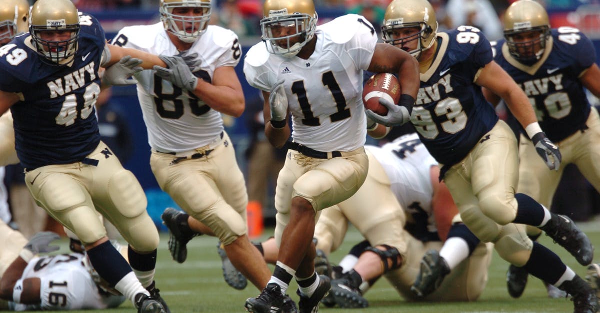 How do I run Commodore 64 games on classicreload.com? - Group of Male Football Players Running on Field during Day