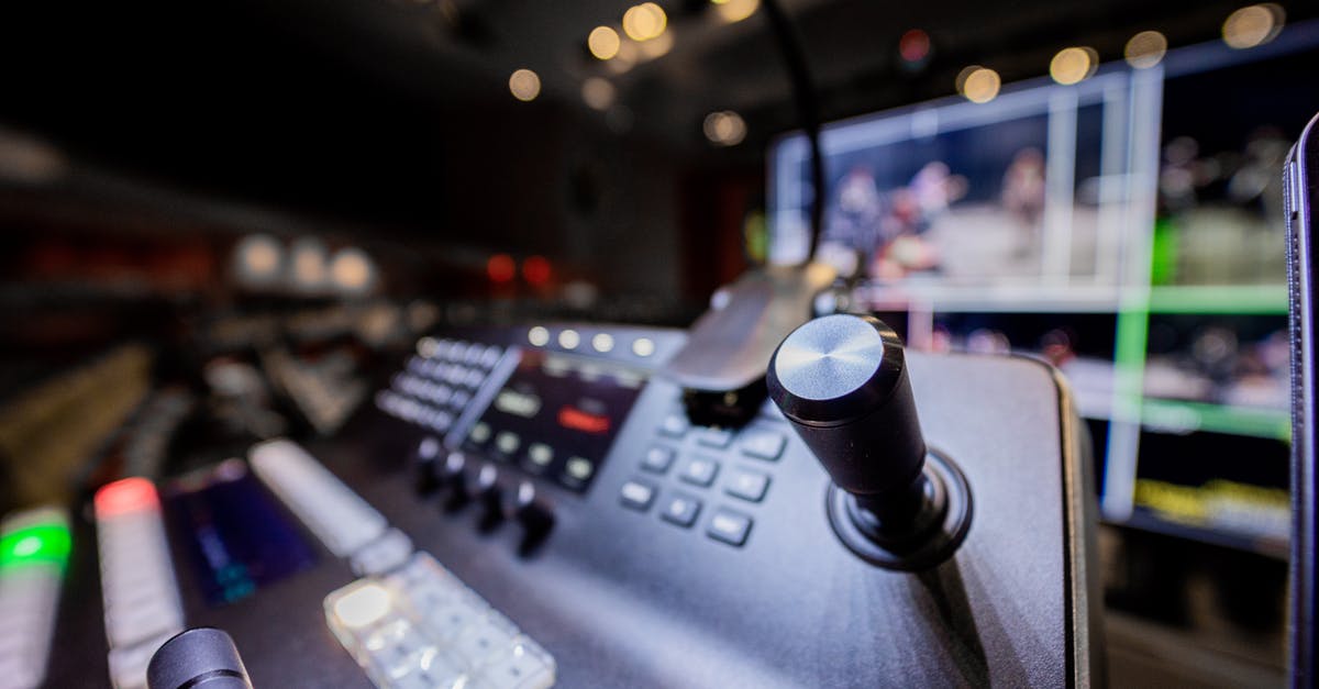 How do I set up Civ 6 on multiple displays? - Closeup of modern professional audio console controller with buttons placed near screen in studio with lights