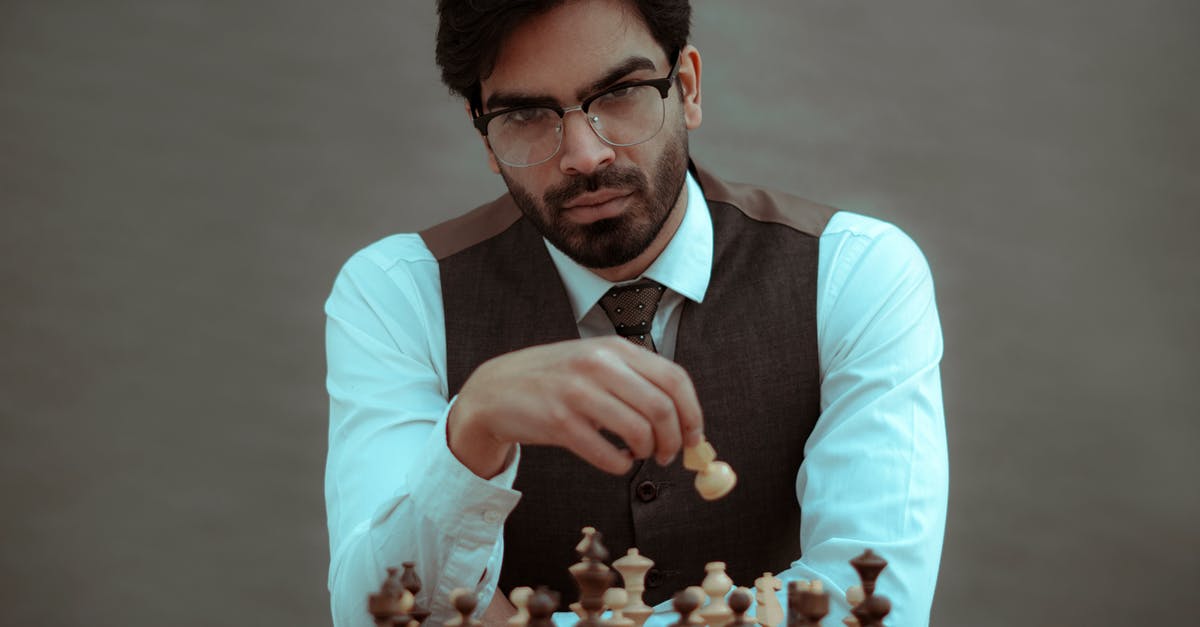 How do I solve this puzzle in The Challenge? - Concentrated masculine bearded ethic male wearing formal clothes sitting at board and making chess move on blurred gray background