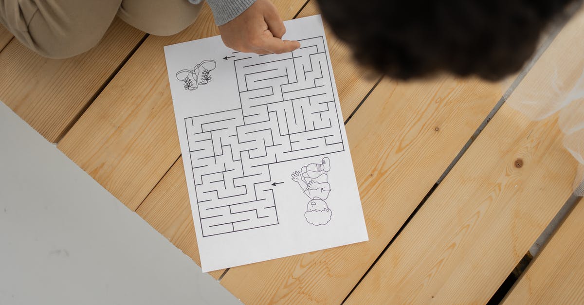 How do I solve this puzzle in The Challenge? - Unrecognizable child solving labyrinth test printed on paper at home