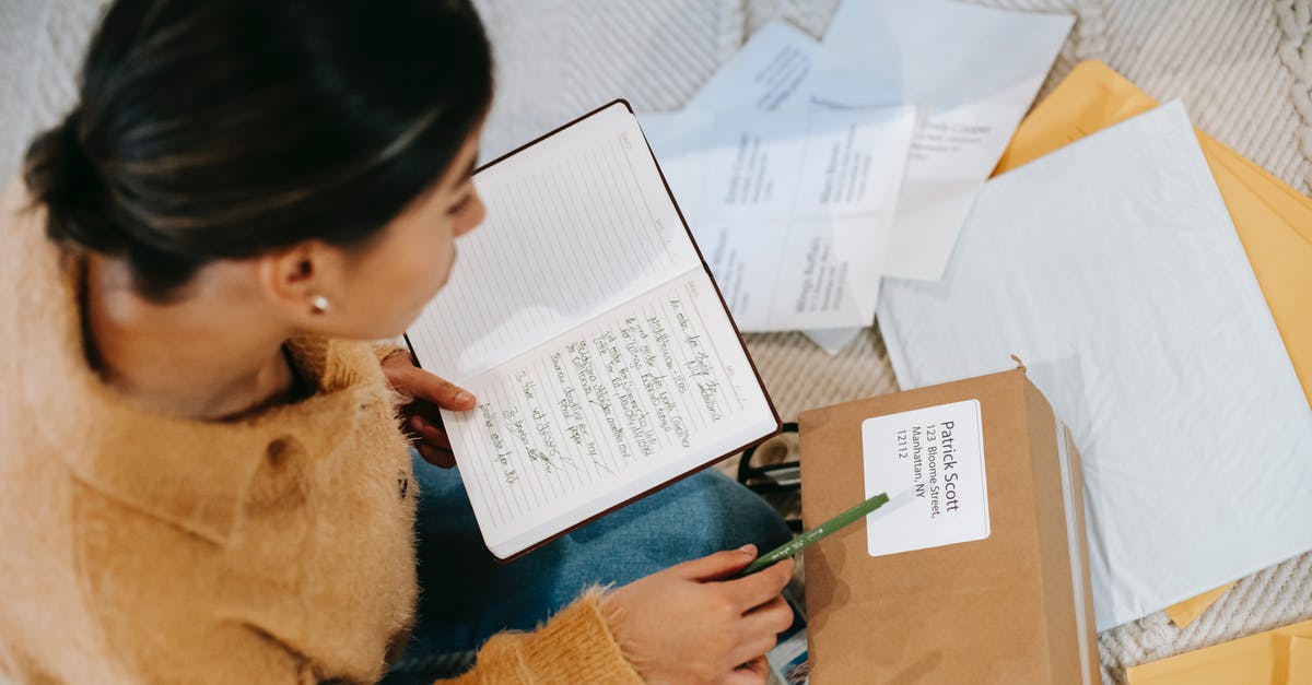 How do I transfer stuff between characters? - From above concentrated young female checking address details on parcel label while sitting on floor with opened diary