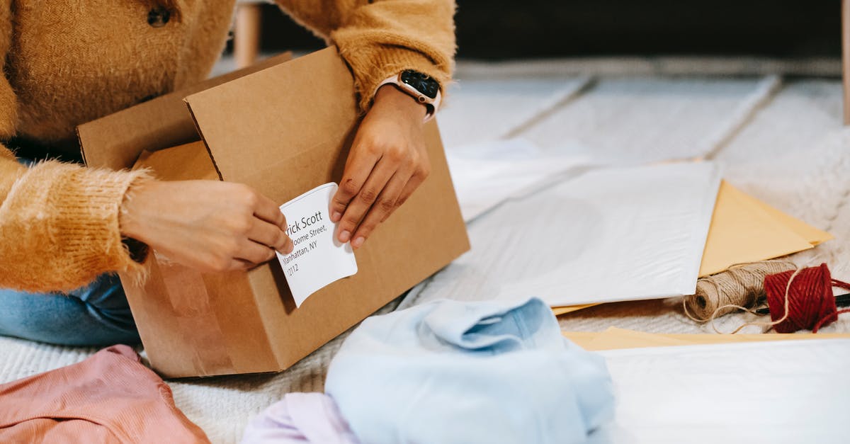 How do I transfer stuff between characters? - Crop unrecognizable woman sticking shipping label on parcel