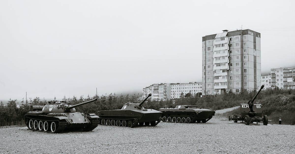 How do I upgrade equipment past 3 stars? - Black and white of monuments of various military vehicles on square in city