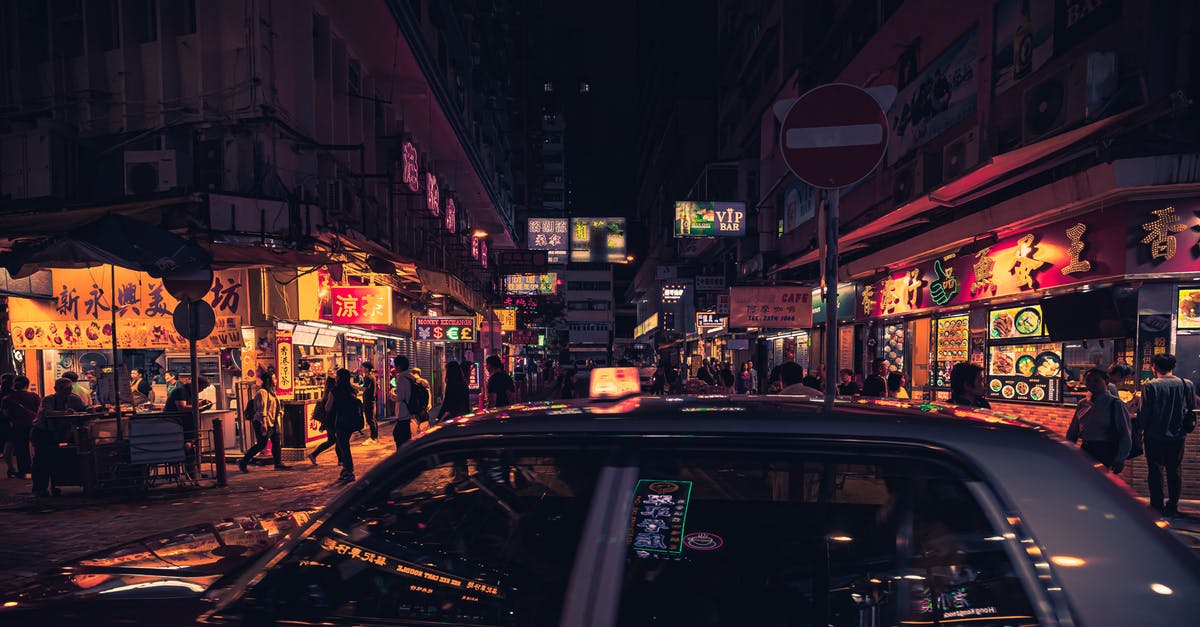 How do travelers work? - Photo of Taxi Near Buildings During Nighttime