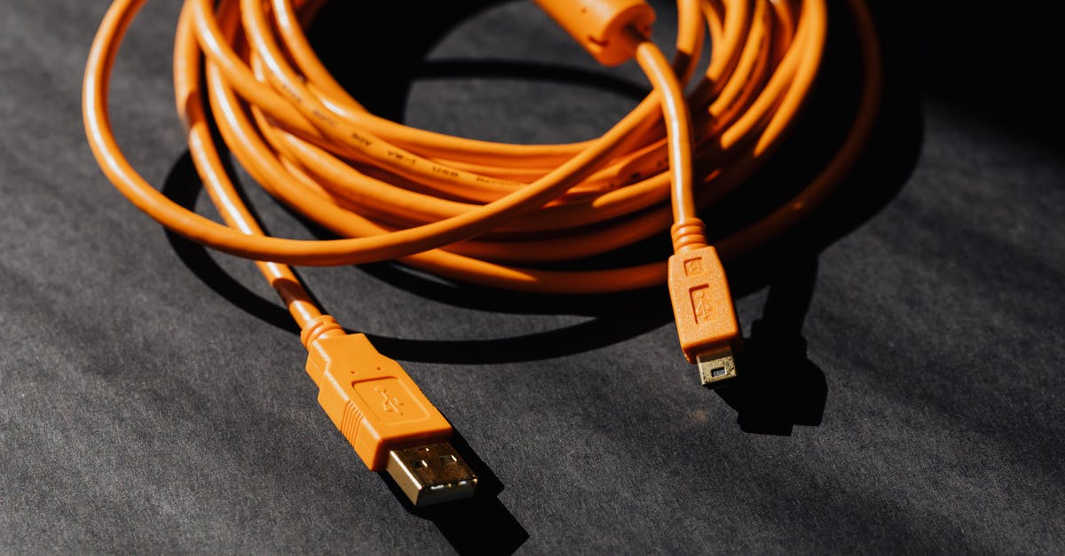 How do you backflip in Elden Ring (with PC controls)? - From above of orange usb to micro usb cable twisted into ring placed on black board