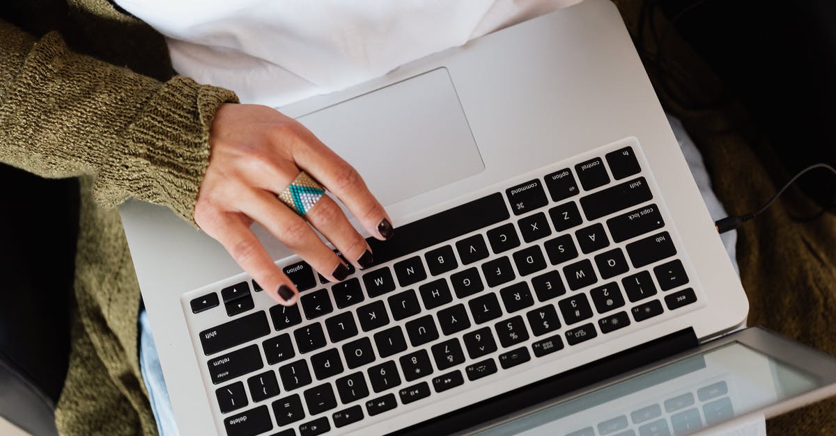 How do you backflip in Elden Ring (with PC controls)? - Top view crop anonymous female wearing knitted casual jacket and stylish ring typing on modern netbook keyboard