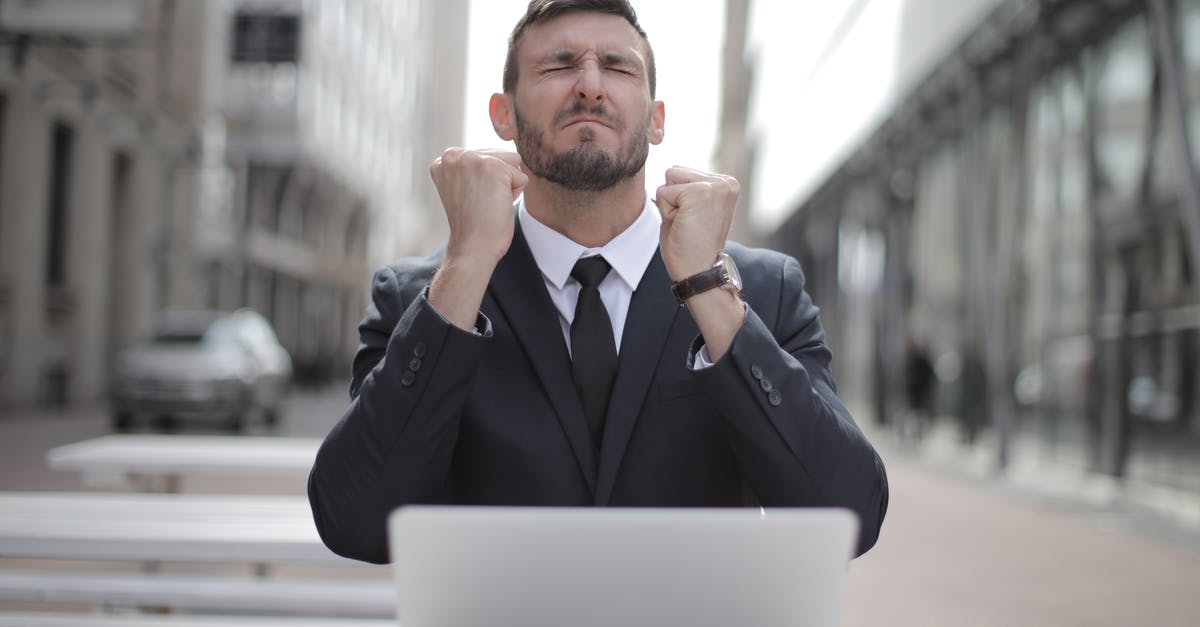 How do you earn Loot Boxes? - Man in Black Suit Sitting on Chair Beside Buildings