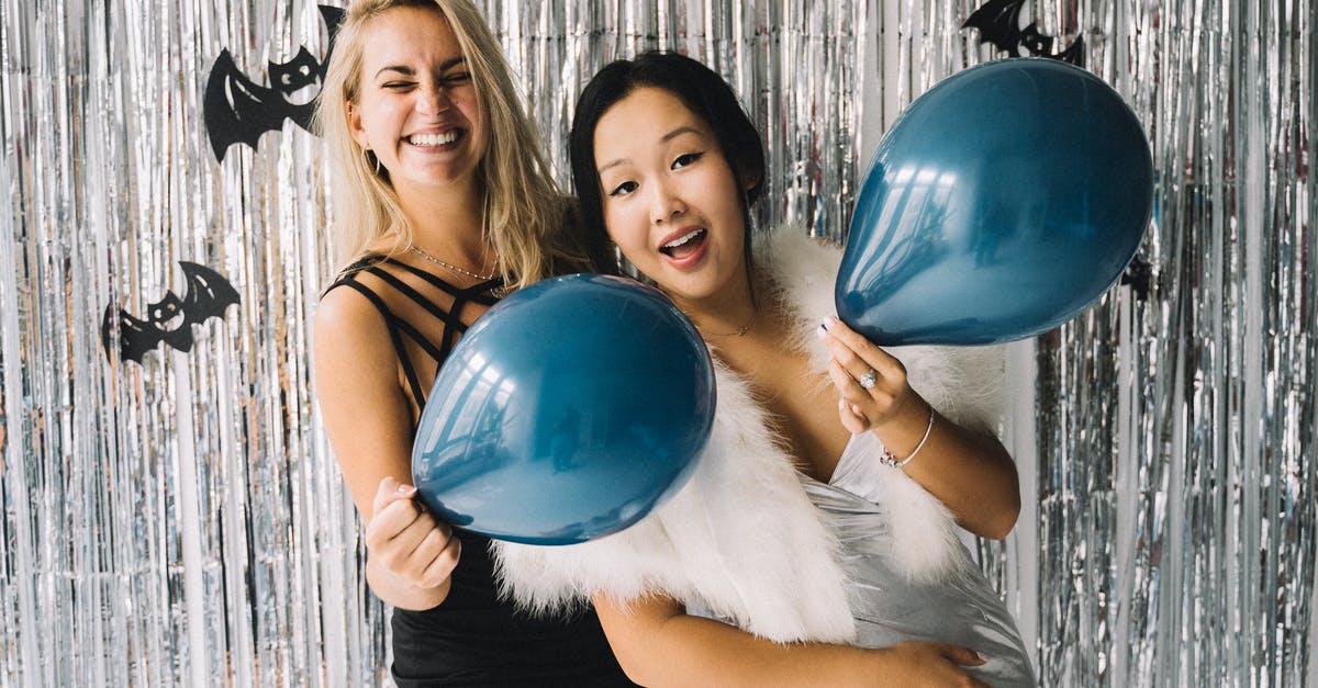 How do you invite friends to the Halloween 2018 Google Doodle? - 2 Women Holding Blue Balloons