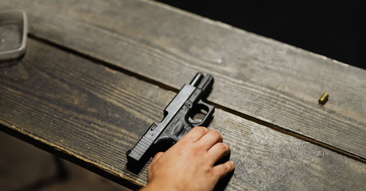 How does 2-handing a weapon affect damage? - Hand of a Person Holding Black Semi Automatic Pistol