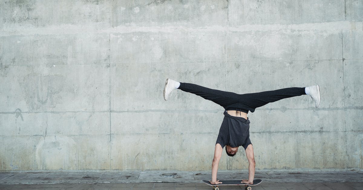 How does an Ability Capsule interact with Hidden Abilities? - Anonymous guy in activewear doing handstand on skateboard while riding alone near concrete wall and pavement