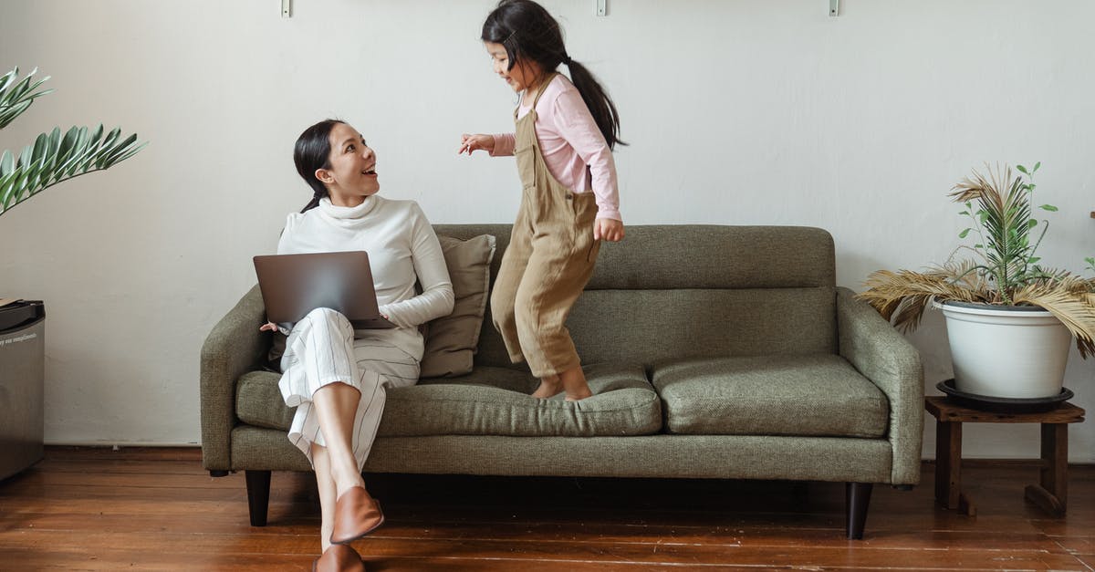 How does Crouch jump actually work? - Happy mother with laptop talking to little daughter on couch