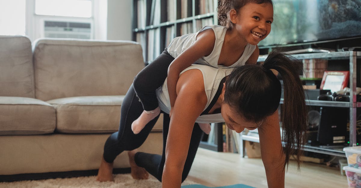 How does difficulty level affect my exercise? - Young Asian woman piggybacking smiling daughter while exercising at home