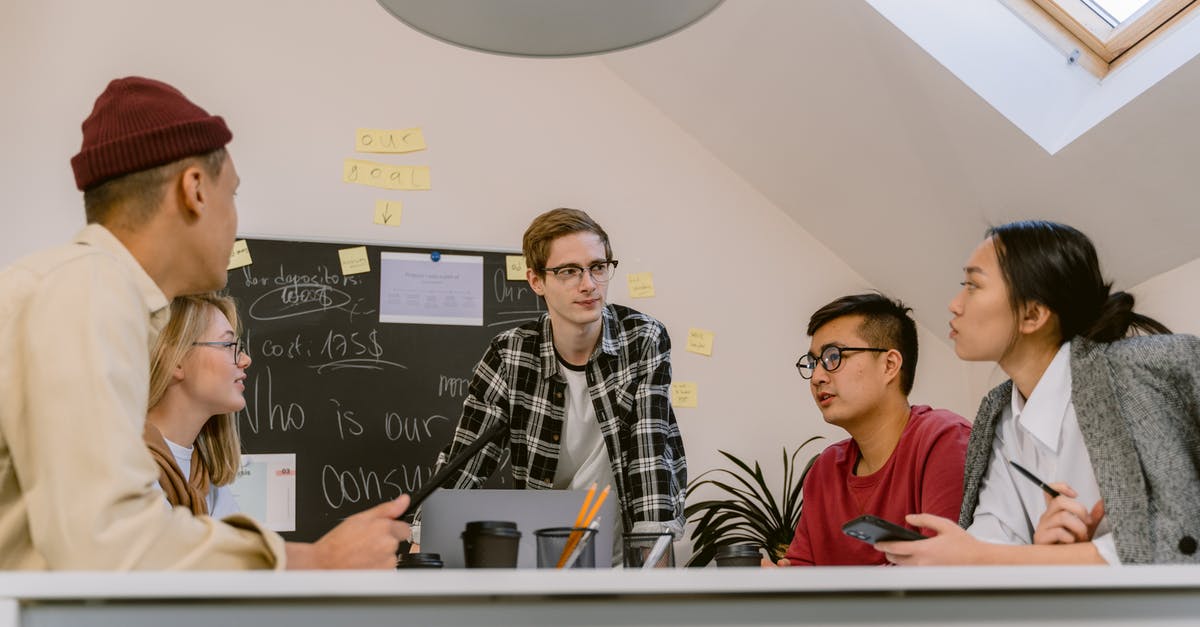 How does MMR work? - Man in Black and White Checkered Dress Shirt Sitting Beside Woman in Red Crew Neck Shirt