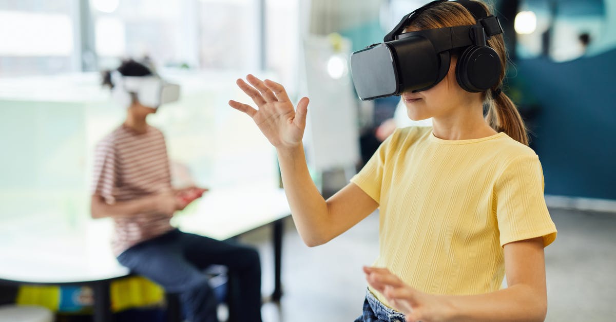 How does perception work? - Young female in VR glasses standing in light room and testing new device