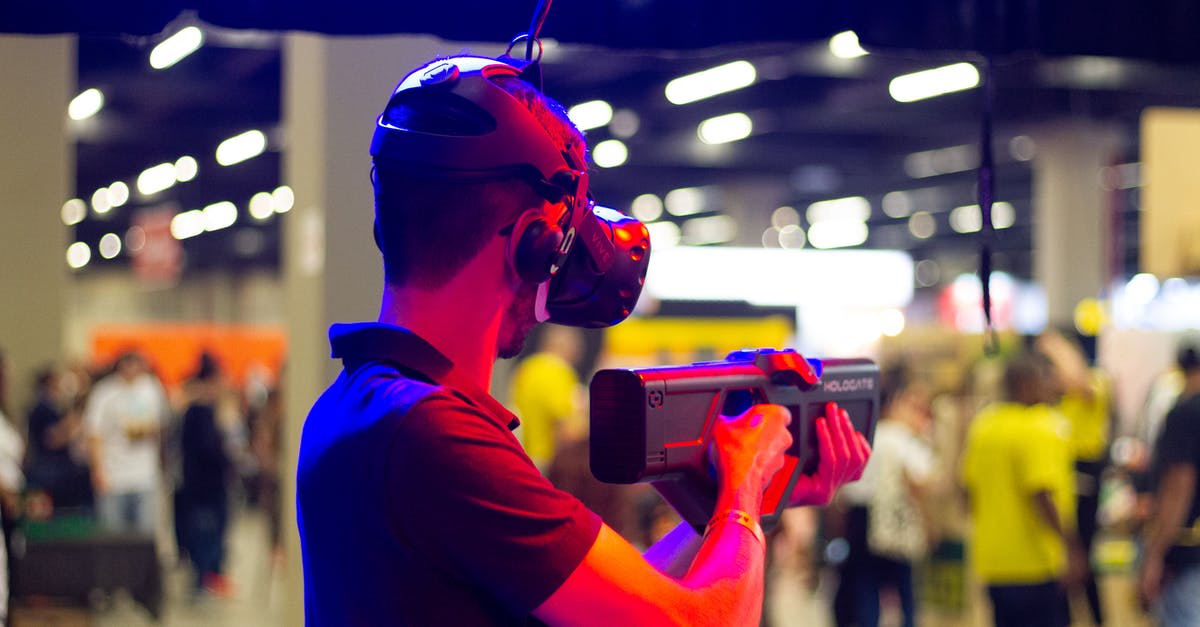 How does perception work? - Back view of young male in casual clothes and VR headset standing in spacious hall while testing device operation