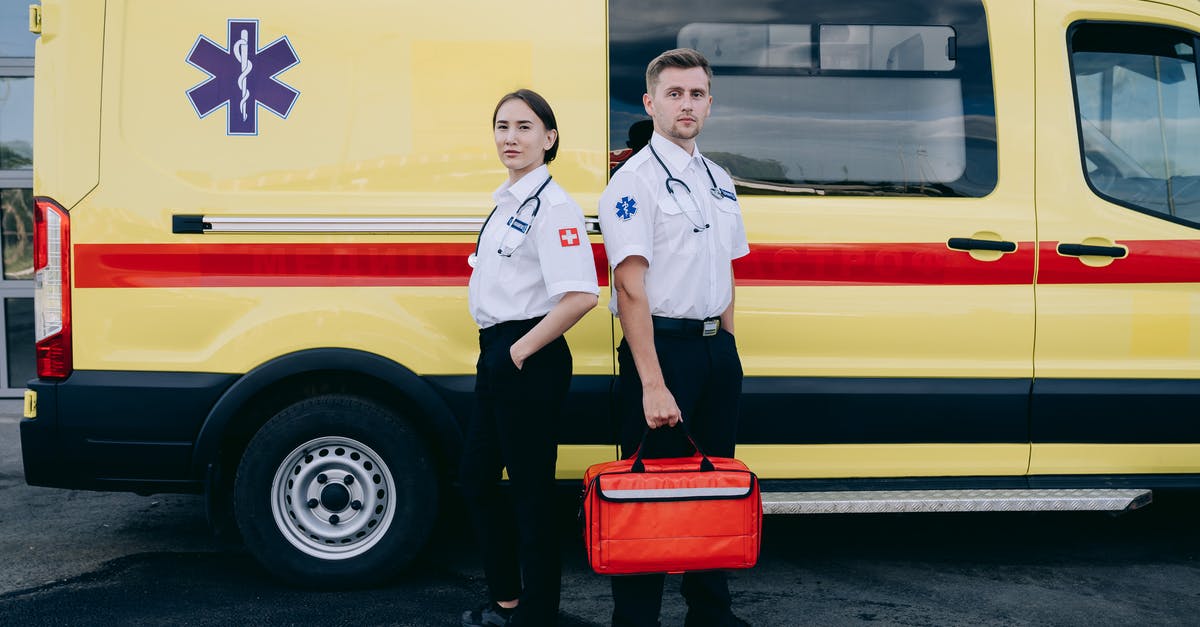 How does rescuing work? - Paramedics Standing Beside an Ambulance