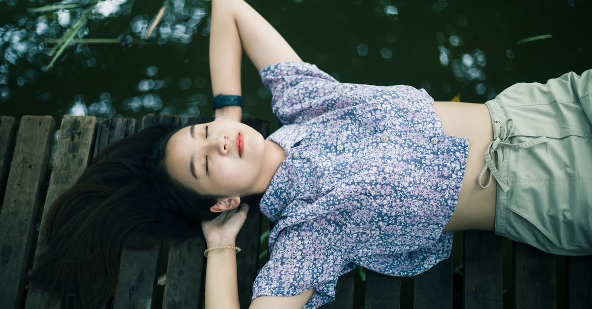 How does Slither.io resolve head-on collisions? - Woman in Blue and White Floral Dress Lying on Brown Wooden Bench