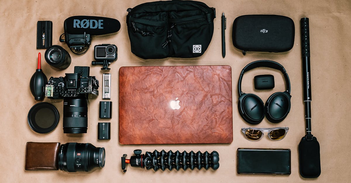 How does the assist system work? - Overhead view of laptop and photo camera composed with headphones and other gadgets of professional photographer