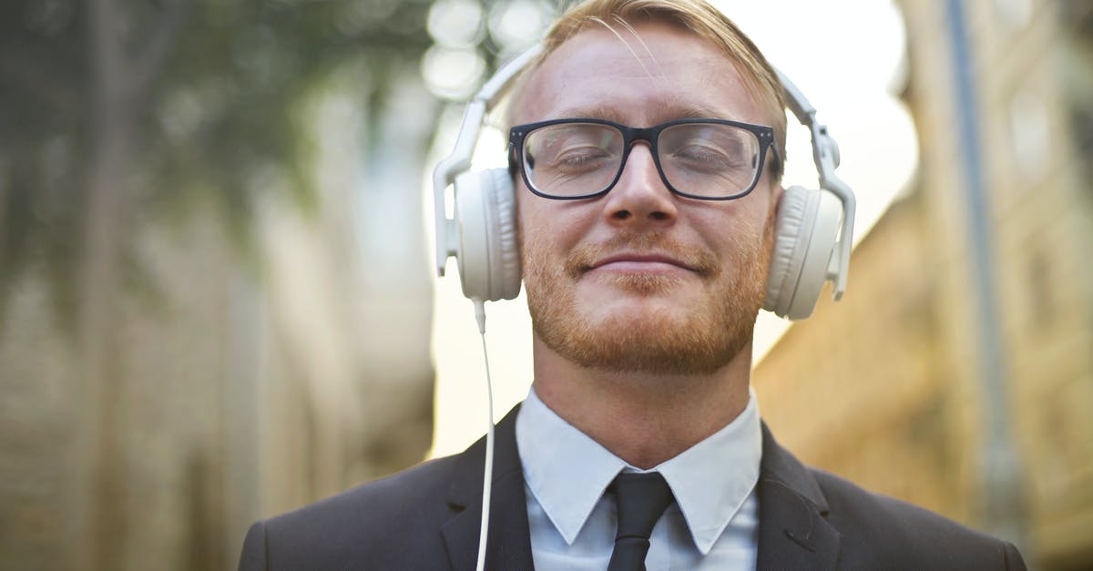 How does the audio visualizer work? - Cheerful man in formal wear enjoying music