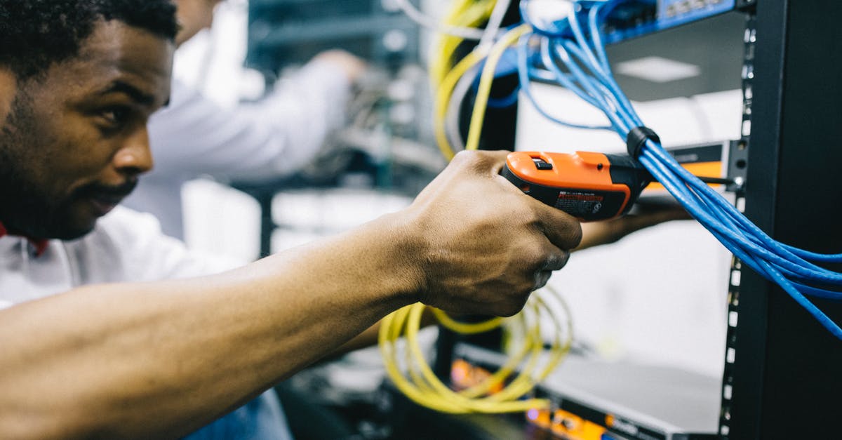 How does the first Control Point in Maintenance work? - Crop focused ethnic engineer using electric screwdriver