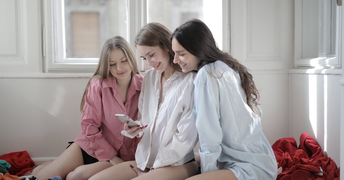 How does the passive item Unity add damage from your other guns? - Group of young women browsing smartphone together in messy room