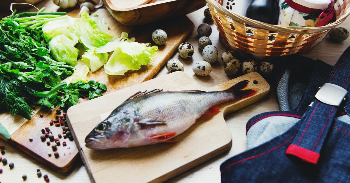 How does Vivi differ from other Black Mages? - Raw fish on cutting board with lettuce in kitchen