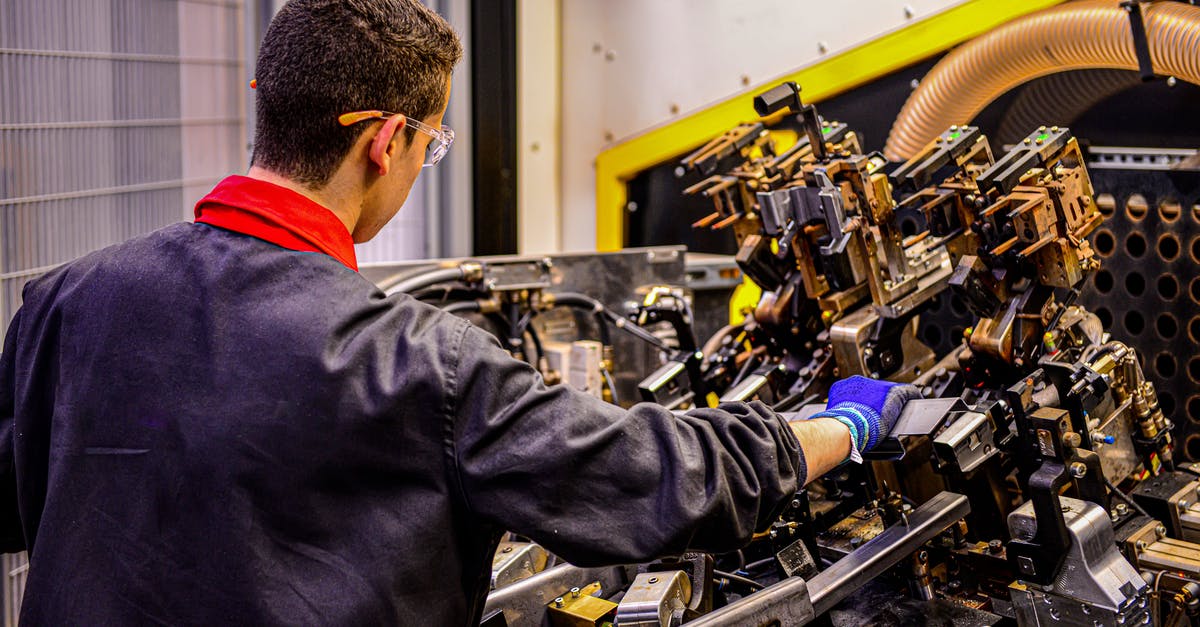 How good would a Divine Metal Industry be? - Man in Black Jacket Using Black and Yellow Power Tool