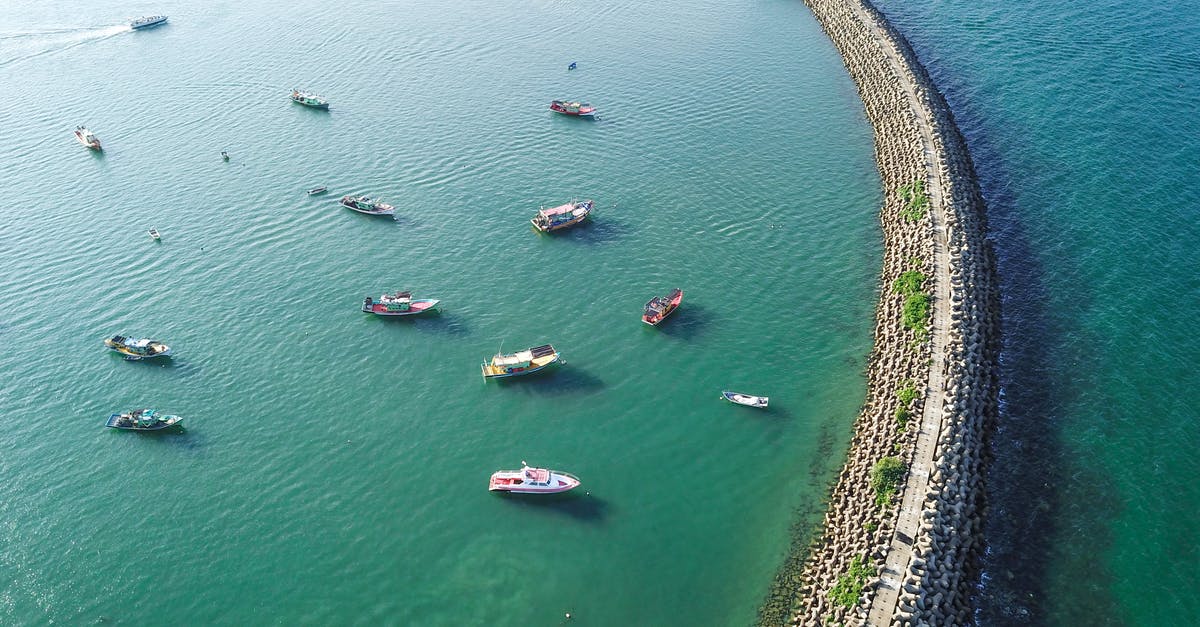 How long do I have to wait for another Massive Mass Outbreak? - Aerial view of turquoise tranquil sea with massive long breakwater construction and many motorboats on clear weather How long do I have to wait for another Massive Mass Outbreak? - Aerial view of turquoise tranquil sea with massive long breakwater construction and many motorboats on clear weather