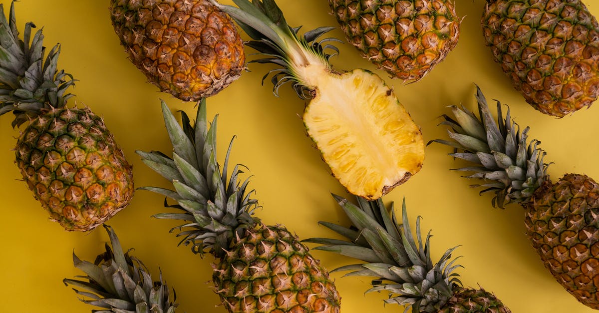 How many Crown Chests can be stacked up at one time? - Top view composition of fresh pineapples with juicy colorful flesh placed on yellow background in light studio during ripening season