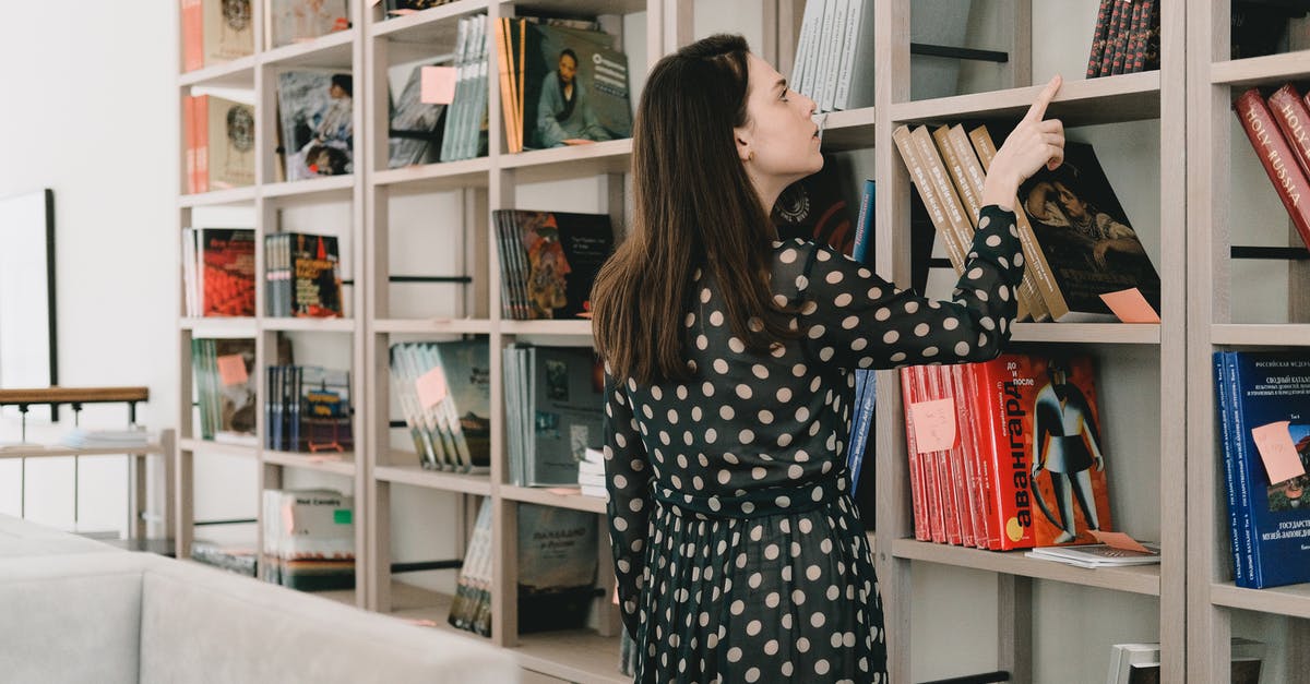 How many free chests can I stack up? - Young woman choosing book from bookshelf