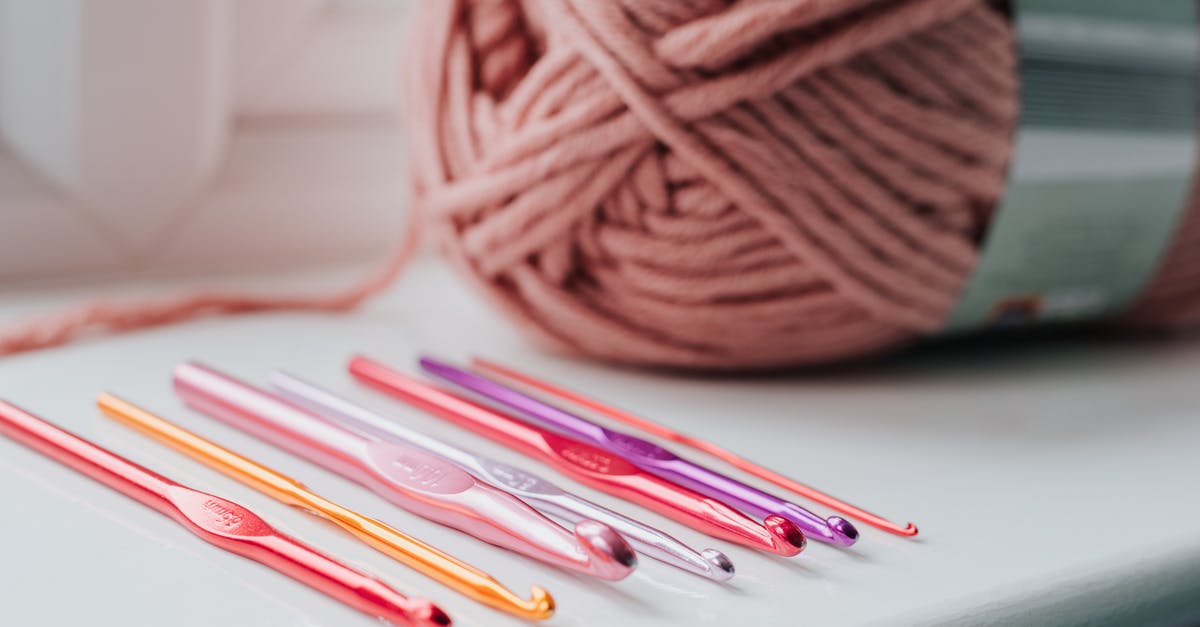 How many games did Romero and Carmack create before Doom? - Closeup of row of multicolored crochet needles and ball of beige threads for knitting in bright room