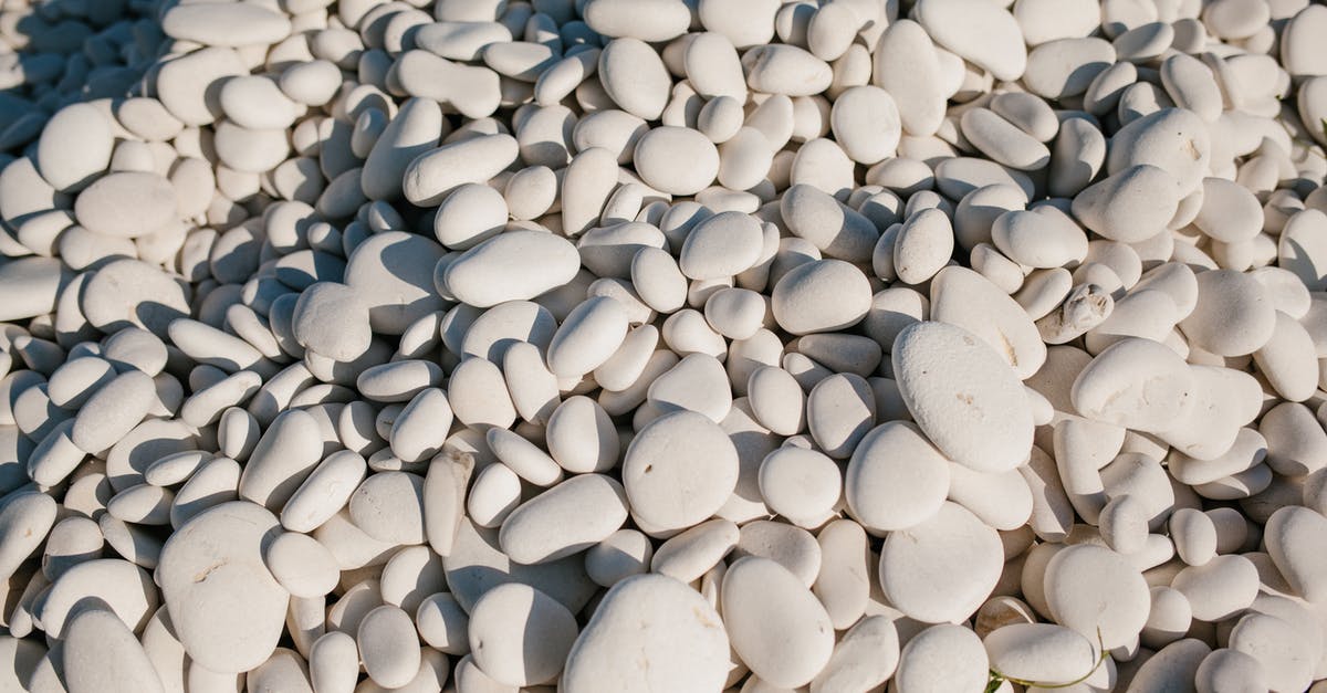 How many mundus stones per zone? - From above of white small smooth and round stones in pile at sunshine