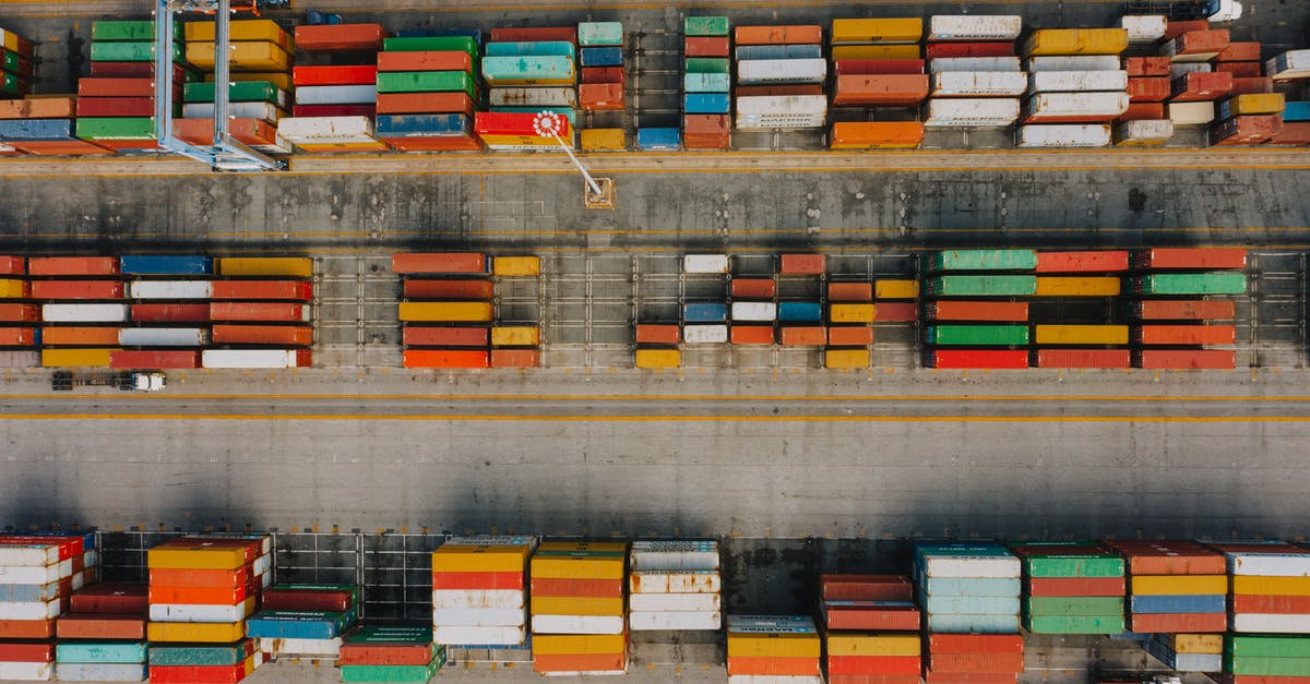 How many original Xbox systems could you system link together? - Drone view of various colorful cargo containers placed in rows on asphalt in daytime