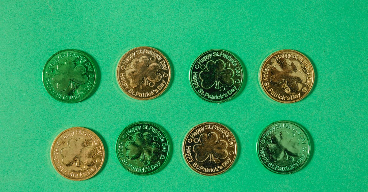 How many seconds are there in a day? - Top view of gold coins with clover pattern arranged in rows on light green surface