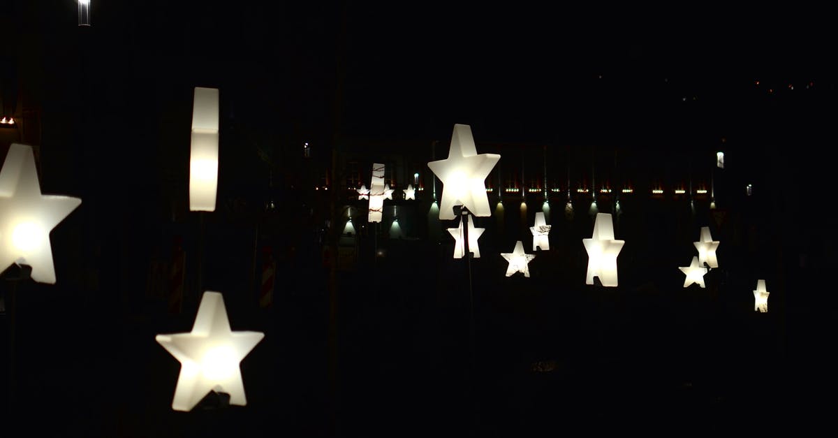 How many stars do you need to get all the badges? - Creative star shaped garlands with glowing lamps decorating street against dark night sky