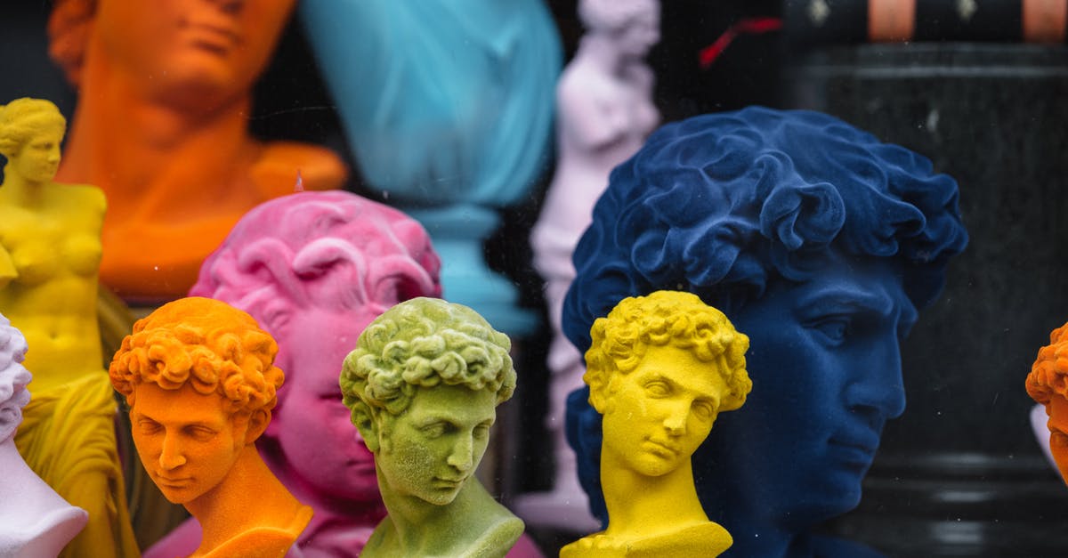 How many statues are there? - Collection of colorful head sculptures of David in different colors and shapes placed on counter in store with decorative souvenirs