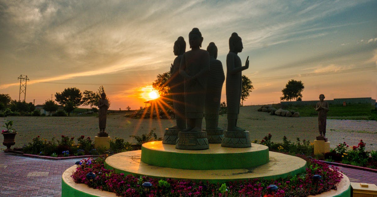 How many statues are there? - 3 People Standing on Pink and White Round Fountain