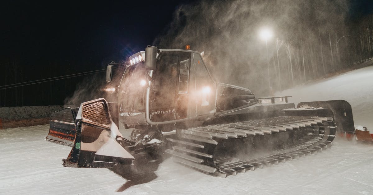 How much does Diffusal Blade slow enemies? - Caterpillar removing snow from road illuminated by streetlight at dusk