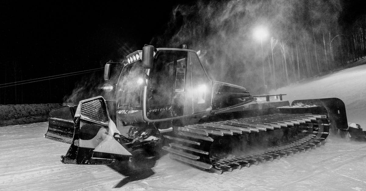 How much does Diffusal Blade slow enemies? - Black and white of snowcat removing snow from roadway against streetlamp under dark sky at night