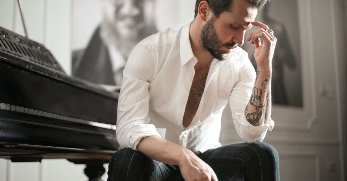 How much experience is needed to reach level 90? - Dramatic tattooed male sitting at piano