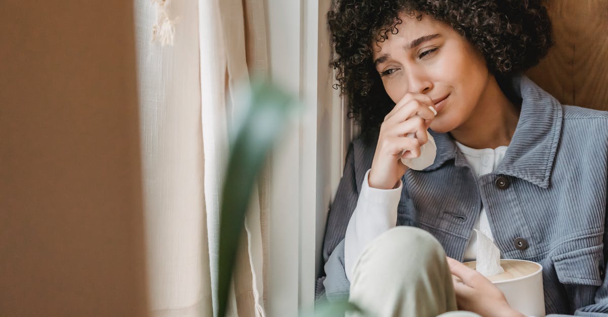 How much H.P. does the B.A.D. bloon have? - Sad African American female with tissue sitting on windowsill and crying while suffering from sorrow