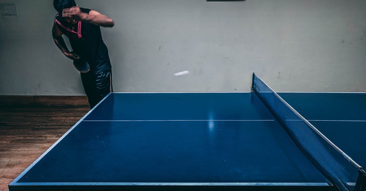 How much room do I need to play Ring Fit Adventure? - Man in Black Shirt Standing Near Blue Wooden Pingpong Table