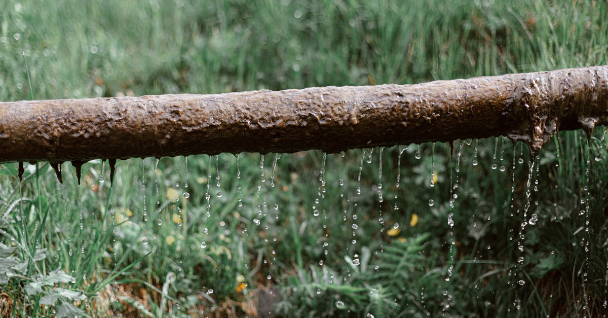 How often do supply drops drop? - Rusted metal leaking pipe above grassy meadow