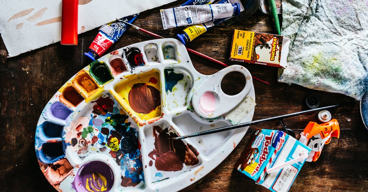 How often vibration is used to indicate item locations? - Top view of various art supplies including paintbrushes with colorful tubes of paint and palette placed on wooden table